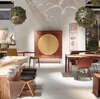 LUNA Geschirrschrank im Wohnambiente – Nussbaum mit goldener Kreisfront auf filigranem Gestell